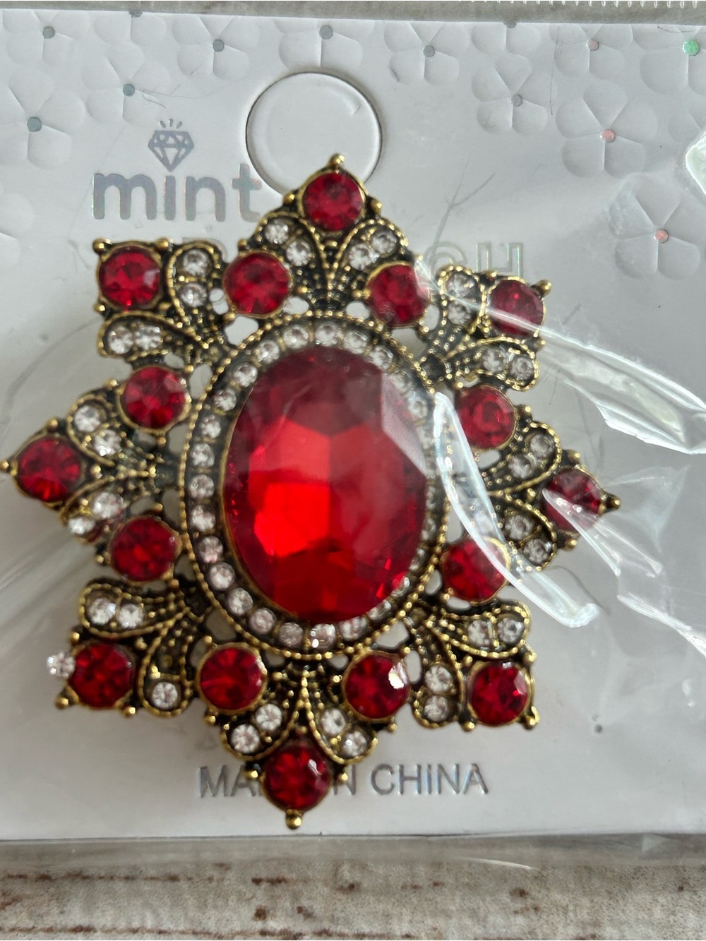 5/)25 Mint Red and Clear Crystal Ornate Brooch in Gold Tone